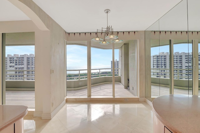 interior space with a chandelier and light tile patterned flooring