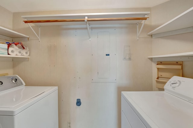 laundry area featuring electric panel and separate washer and dryer