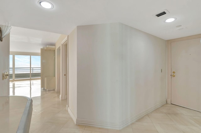 hall featuring light tile patterned flooring