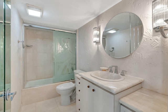 full bathroom featuring tile patterned flooring, shower / bath combination with glass door, toilet, and vanity