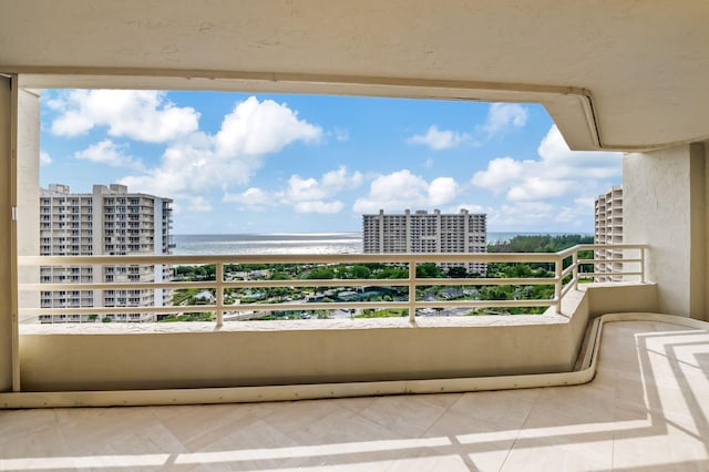 balcony with a view of the beach and a water view