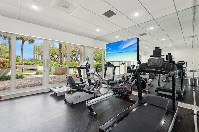 exercise room with plenty of natural light and a drop ceiling