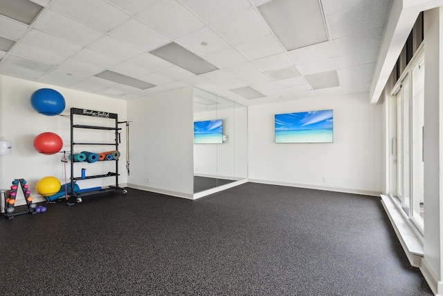 exercise area featuring a paneled ceiling