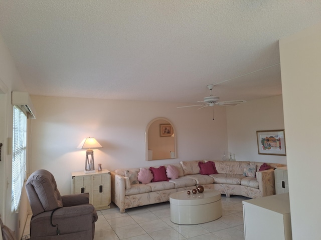 tiled living room with ceiling fan and a textured ceiling