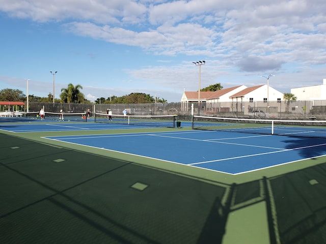 view of tennis court featuring basketball hoop