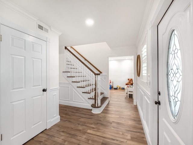 entryway featuring hardwood / wood-style floors and ornamental molding