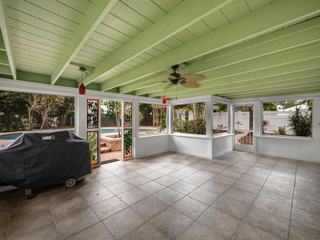 unfurnished sunroom with wooden ceiling, beamed ceiling, and ceiling fan