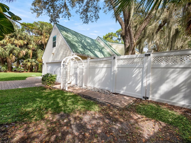 view of home's exterior featuring a lawn and a garage