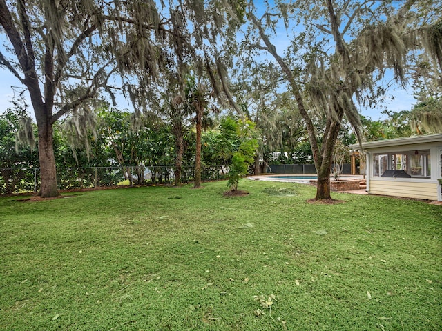 view of yard with a fenced in pool