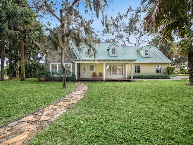 view of front of home with a front yard and covered porch