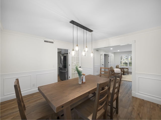 dining room with dark hardwood / wood-style floors and ornamental molding