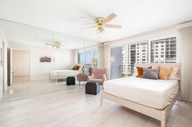 bedroom with ceiling fan and light hardwood / wood-style flooring