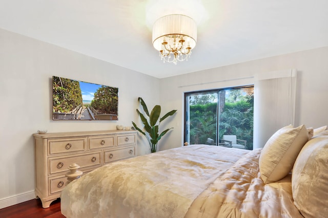 bedroom featuring a chandelier and dark hardwood / wood-style flooring