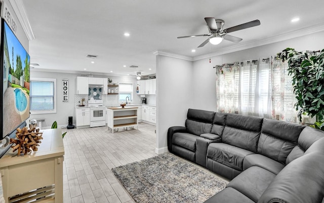 living room with a wealth of natural light and crown molding