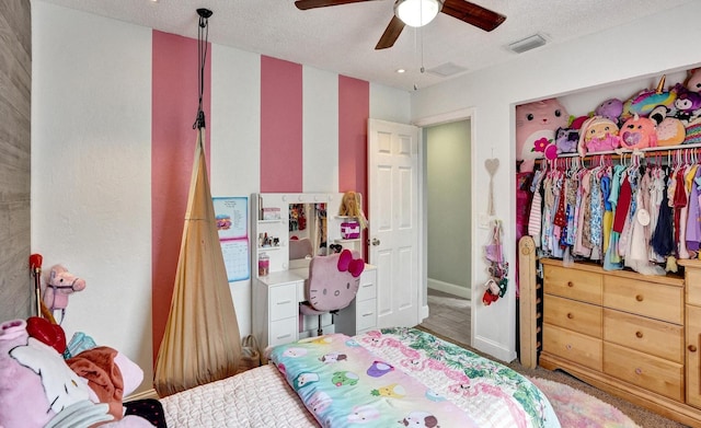 bedroom with a textured ceiling, ceiling fan, and baseboards