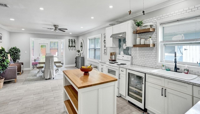 kitchen featuring white cabinetry, wine cooler, and white electric stove