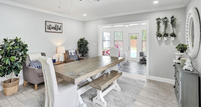 dining area with light hardwood / wood-style flooring, ceiling fan, and crown molding