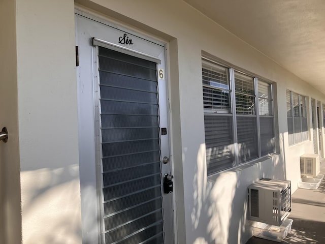 entrance to property featuring cooling unit