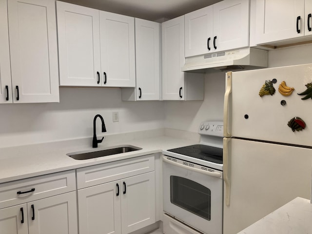 kitchen featuring white appliances, light stone counters, white cabinetry, and sink