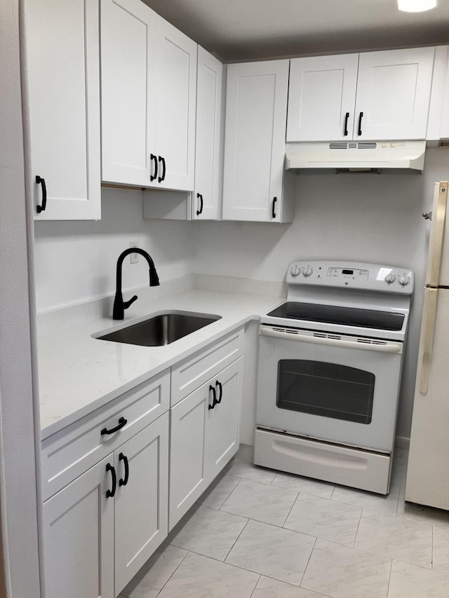 kitchen with white cabinets, light stone counters, white appliances, and sink