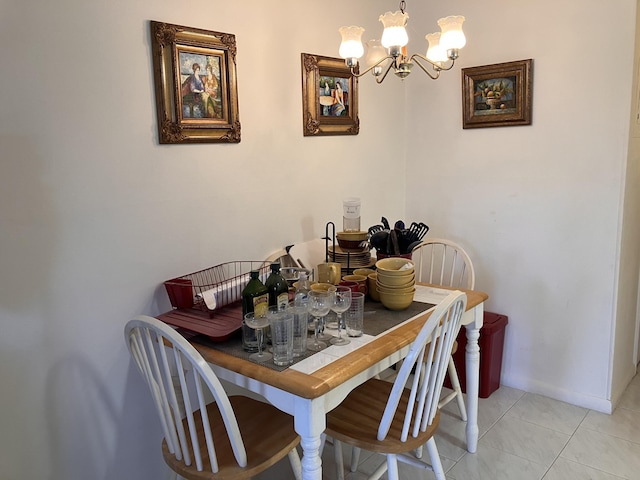 tiled dining room with an inviting chandelier