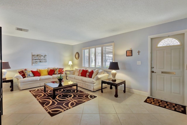 tiled living room with a textured ceiling