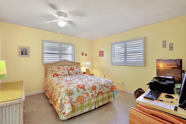 bedroom featuring ceiling fan, light tile patterned flooring, and a textured ceiling