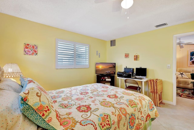 bedroom with ceiling fan and light tile patterned floors