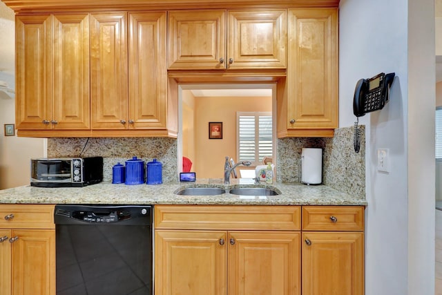 kitchen featuring backsplash, dishwasher, light stone counters, and sink