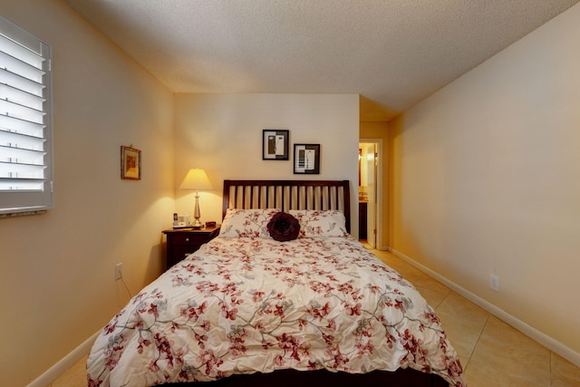 tiled bedroom featuring a textured ceiling