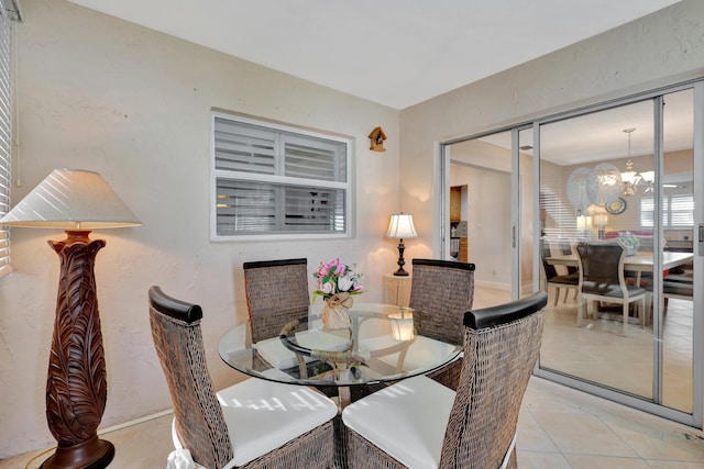 tiled dining room featuring a notable chandelier