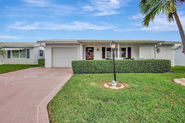 ranch-style house featuring a front yard and a garage