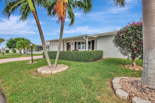 ranch-style home featuring a garage and a front yard