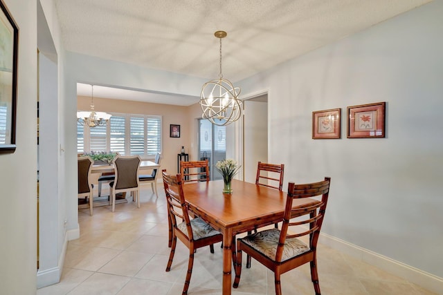 dining room featuring light tile patterned flooring, a chandelier, and a textured ceiling