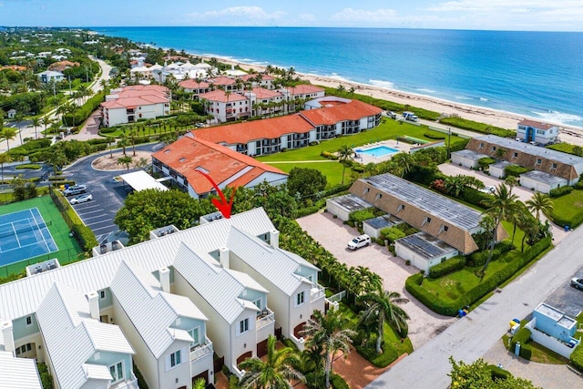 birds eye view of property featuring a beach view and a water view