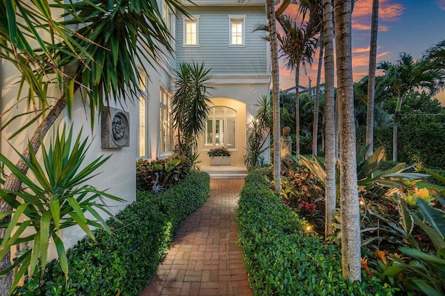 yard at dusk featuring french doors