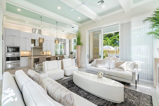 living room with ornamental molding, hardwood / wood-style flooring, and beam ceiling