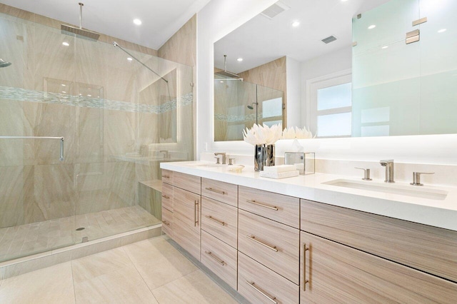 bathroom with vanity, a shower with door, and tile patterned flooring