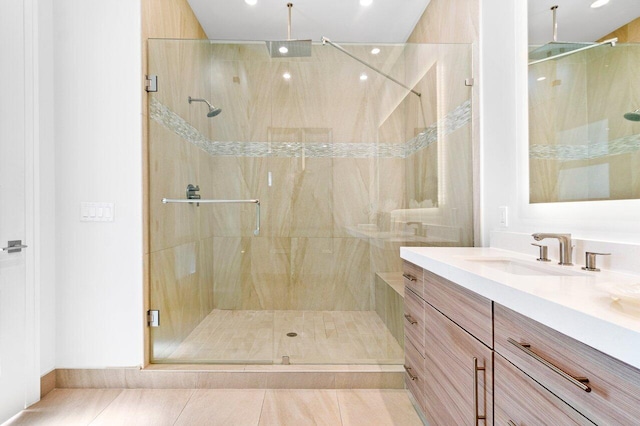 bathroom with vanity, tile patterned floors, and a shower with door