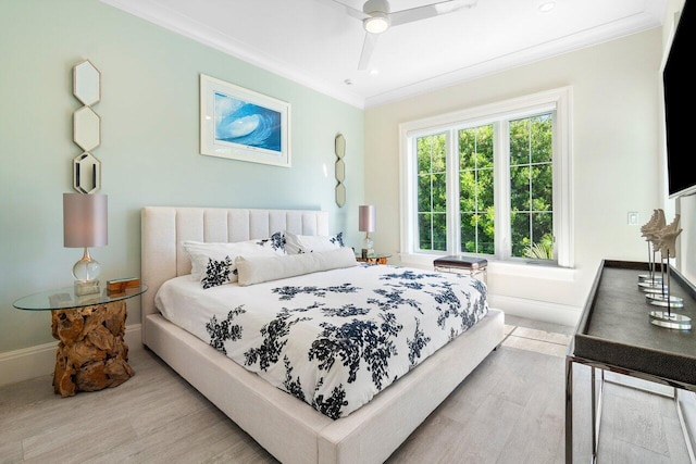 bedroom with light wood-type flooring, ceiling fan, and crown molding