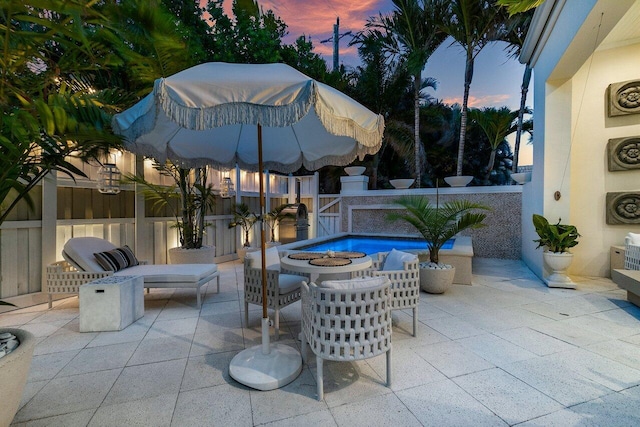 view of patio terrace at dusk