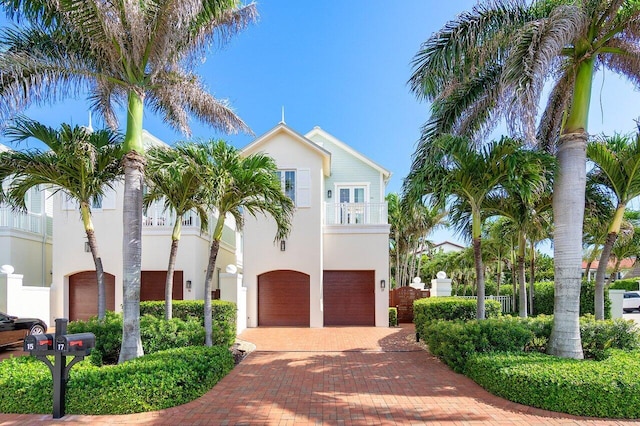 view of front of home with a garage and a balcony