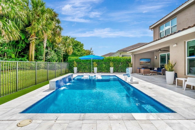 view of swimming pool featuring outdoor lounge area, ceiling fan, pool water feature, and a patio