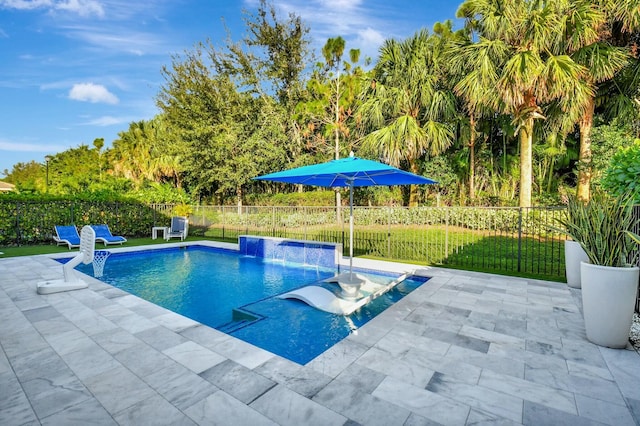 view of pool featuring a patio area, pool water feature, and a yard