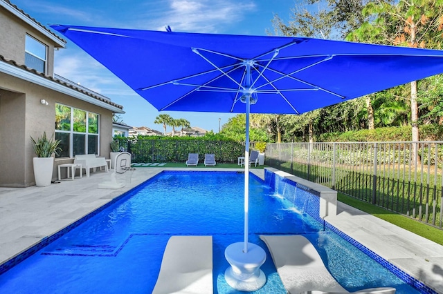 view of swimming pool featuring pool water feature and a patio area