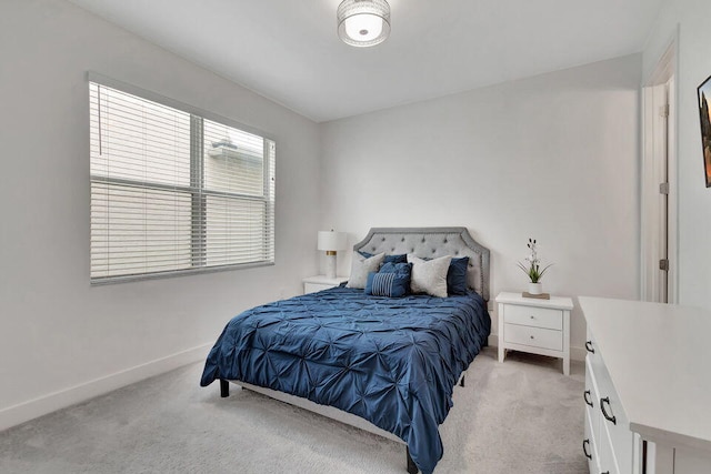 bedroom with multiple windows and light colored carpet