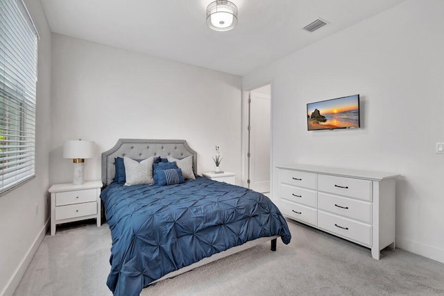 bedroom featuring light carpet