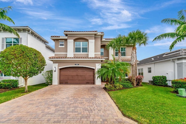 mediterranean / spanish-style house with a front lawn and a garage