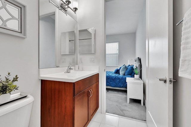 bathroom featuring tile patterned floors, vanity, and toilet