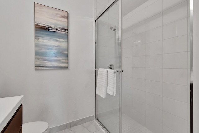 bathroom featuring toilet, vanity, and walk in shower